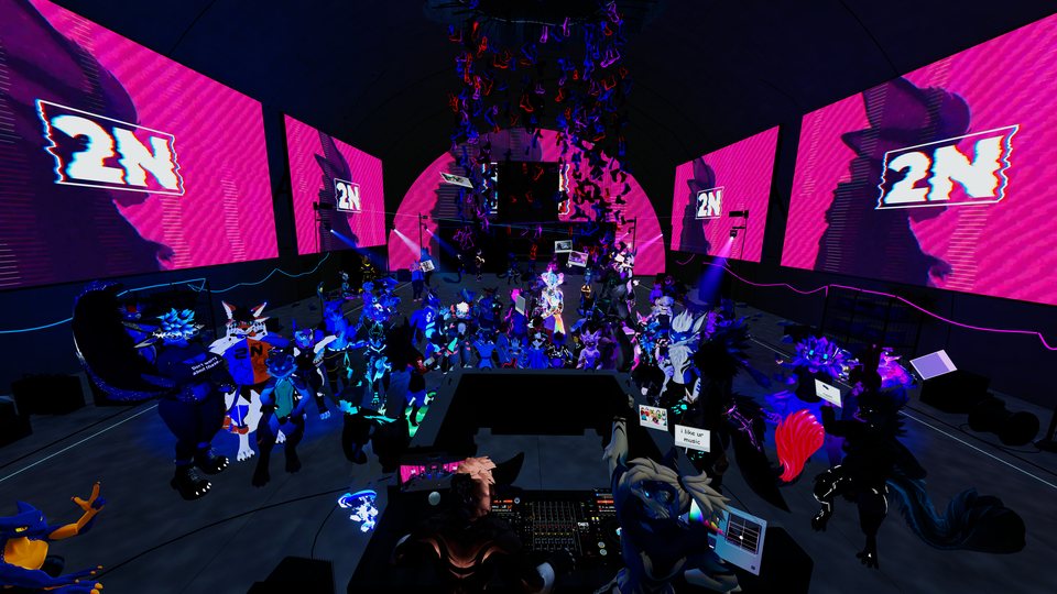 A wide view of the Convergence crowd facing a brightly lit pink and purple stage.